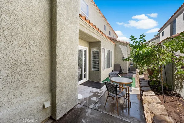 a balcony with chairs and a table