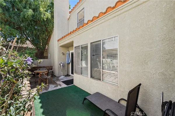 a view of a house with backyard sitting area and garden
