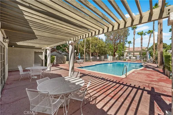 a swimming pool with patio outdoor seating and yard