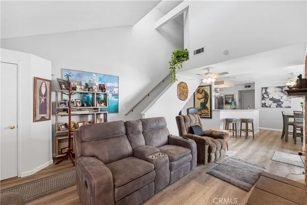 a living room with furniture and kitchen view