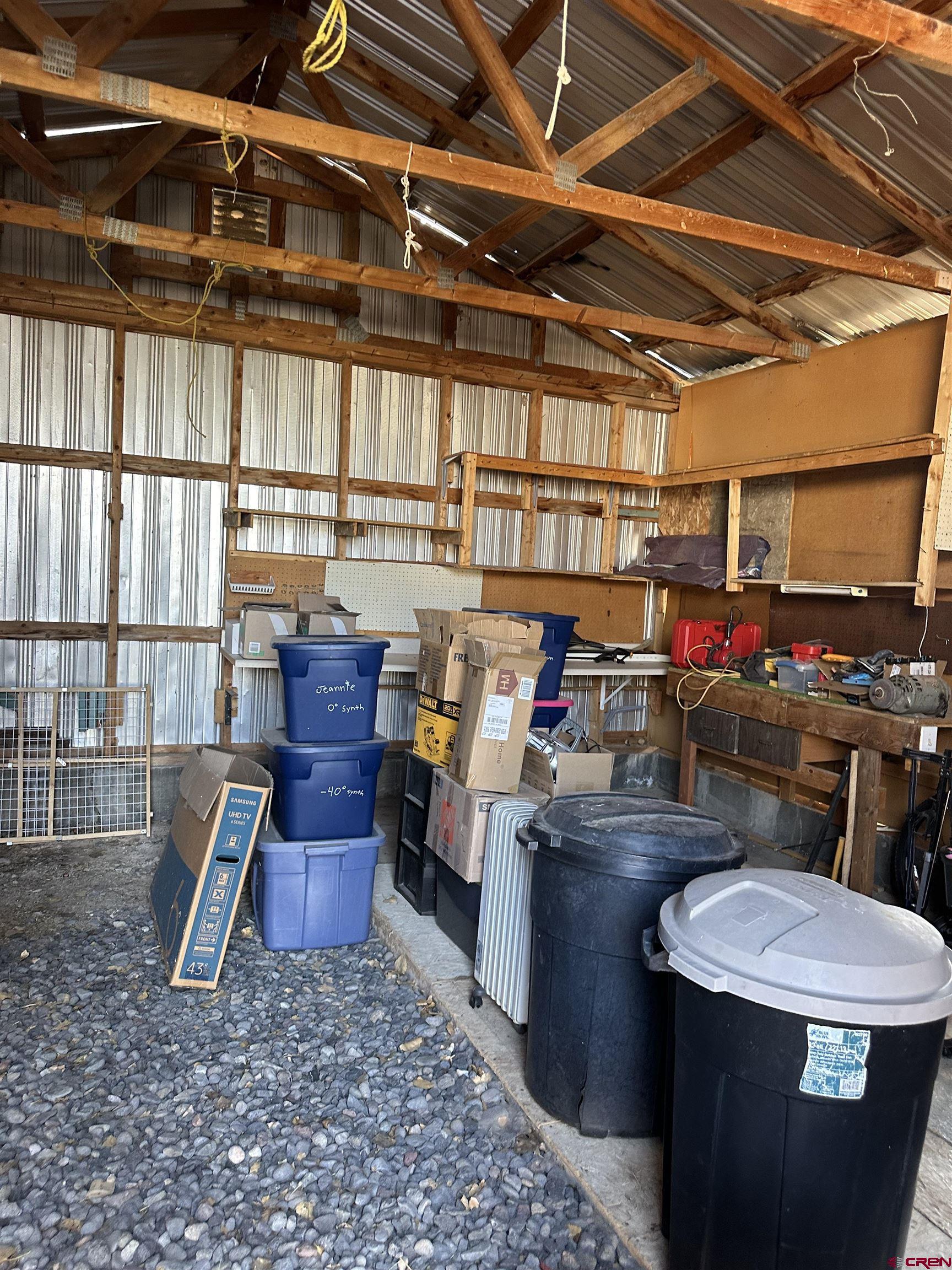 16432 Bull Mesa Road Cedaredge, CO 81413 - Photo 14 of 15 a room with lots of furniture and clutter
