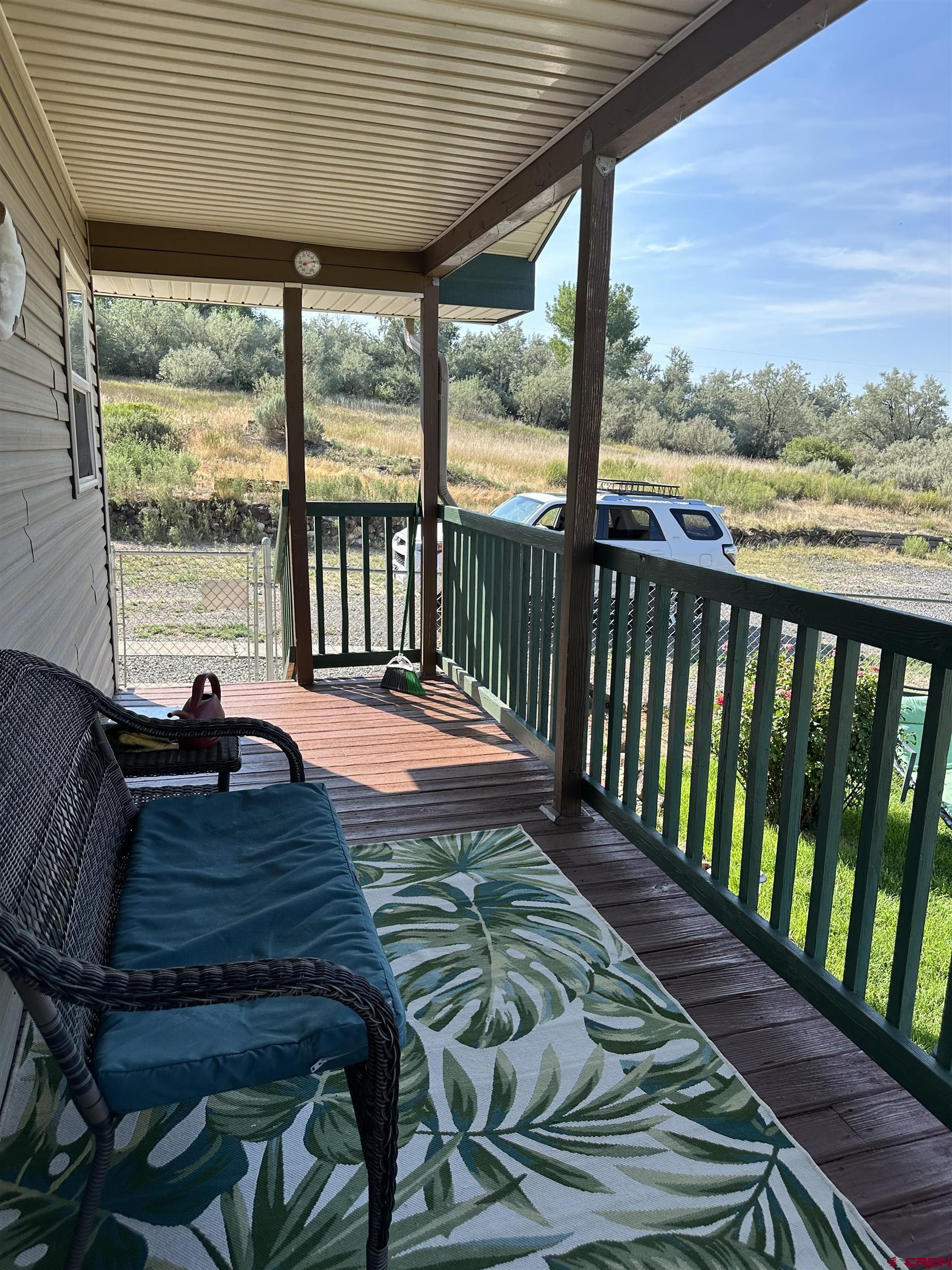 16432 Bull Mesa Road Cedaredge, CO 81413 - Photo 3 of 15 a balcony with table and chairs