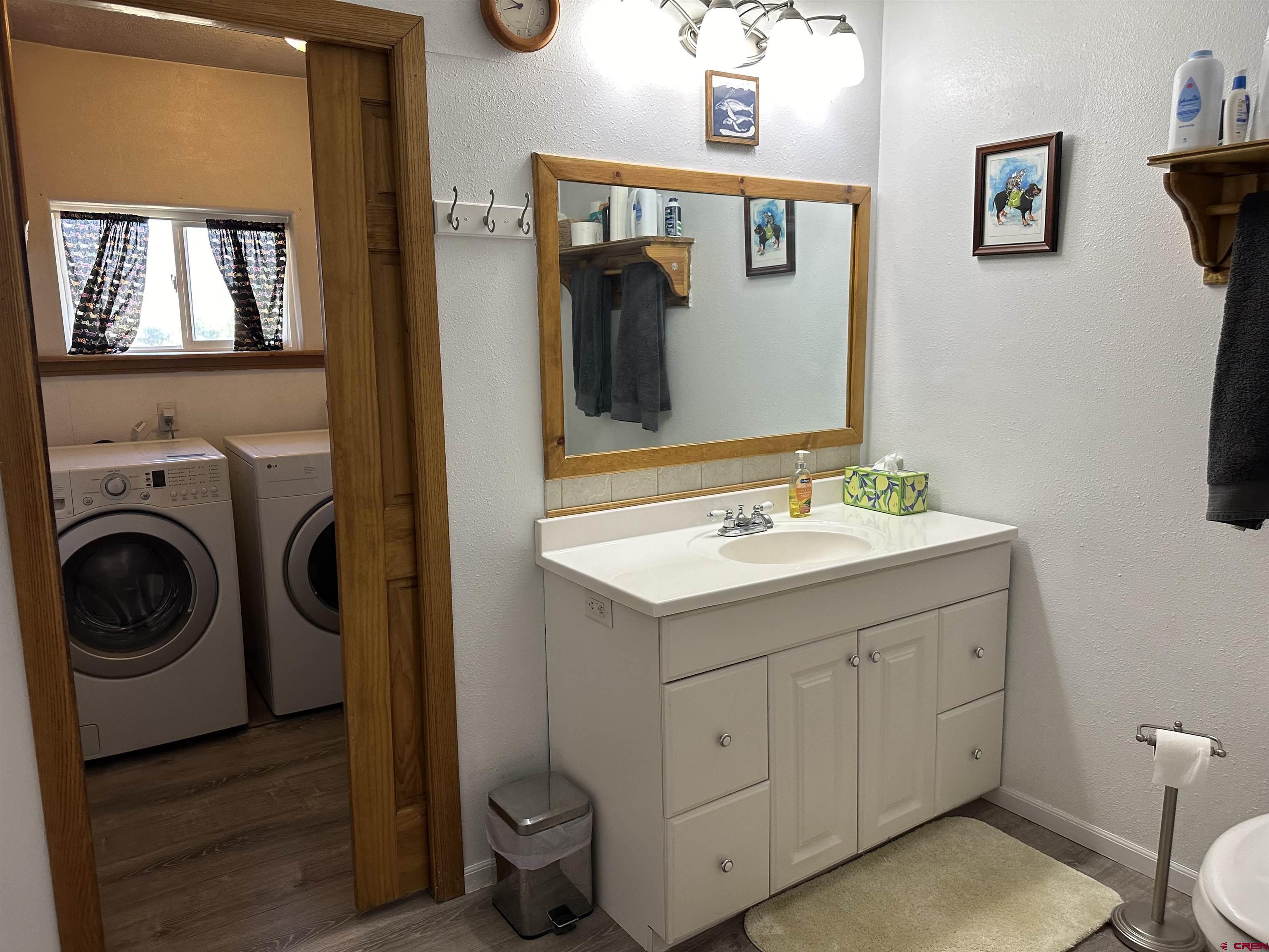 16432 Bull Mesa Road Cedaredge, CO 81413 - Photo 7 of 15 a bathroom with a toilet sink and mirror