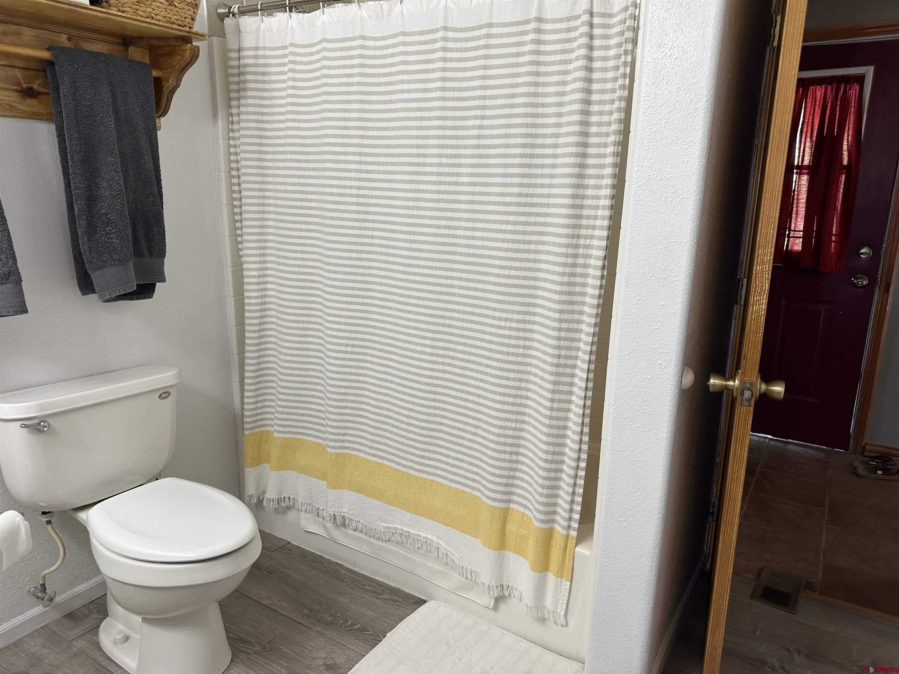 16432 Bull Mesa Road Cedaredge, CO 81413 - Photo 8 of 15 a bathroom with a toilet and a shower