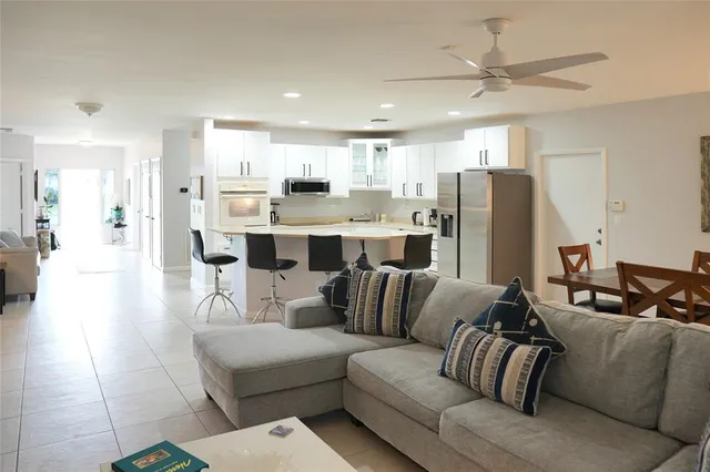 a living room with furniture and a painting on the wall