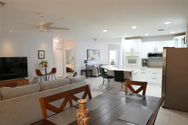 a bedroom with a bed lamps and a table