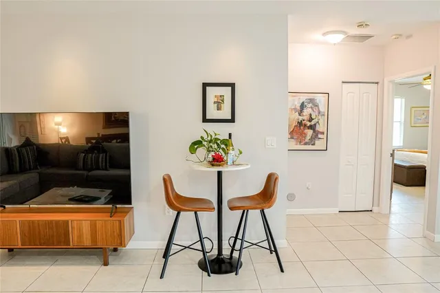 a work place that has a desk and chair next to a window