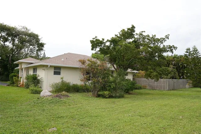 a living room with furniture kitchen view and a refrigerator