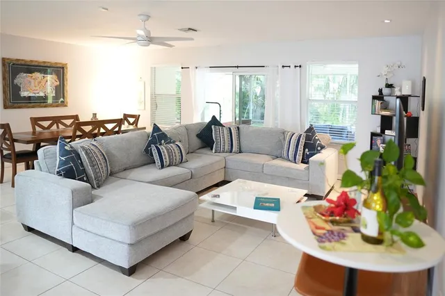 a living room with furniture and a painting on the wall