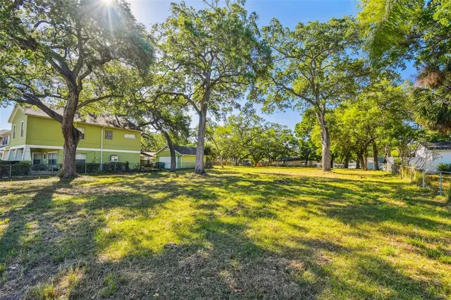 a view of yard with swimming pool and trees