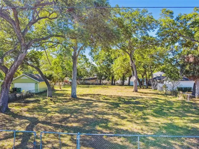 a swimming pool with trees in the background