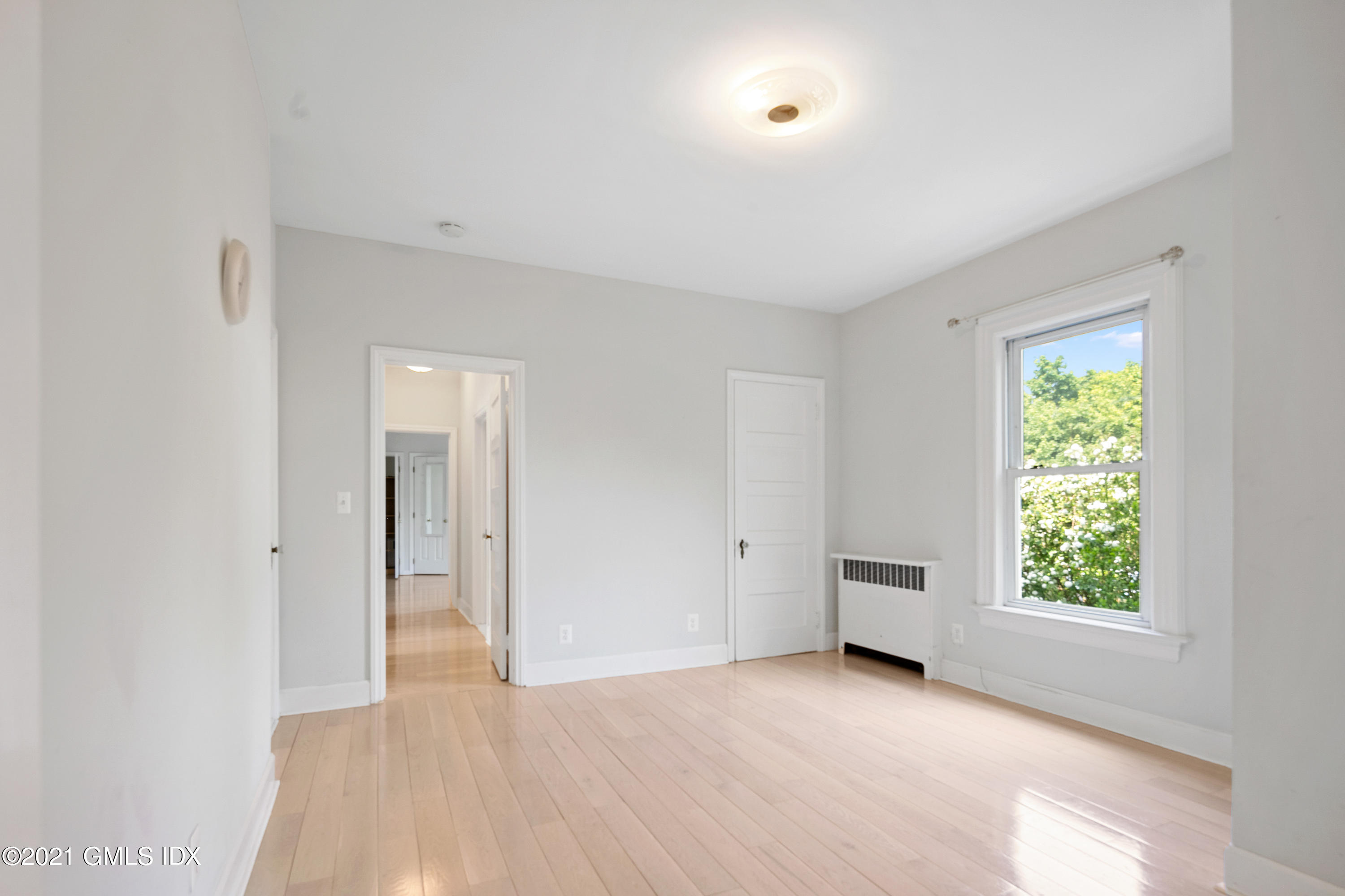 14 Byram Shore Road, Unit 1 Greenwich, CT 06830 - Photo 11 of 30 an empty room with wooden floor and windows