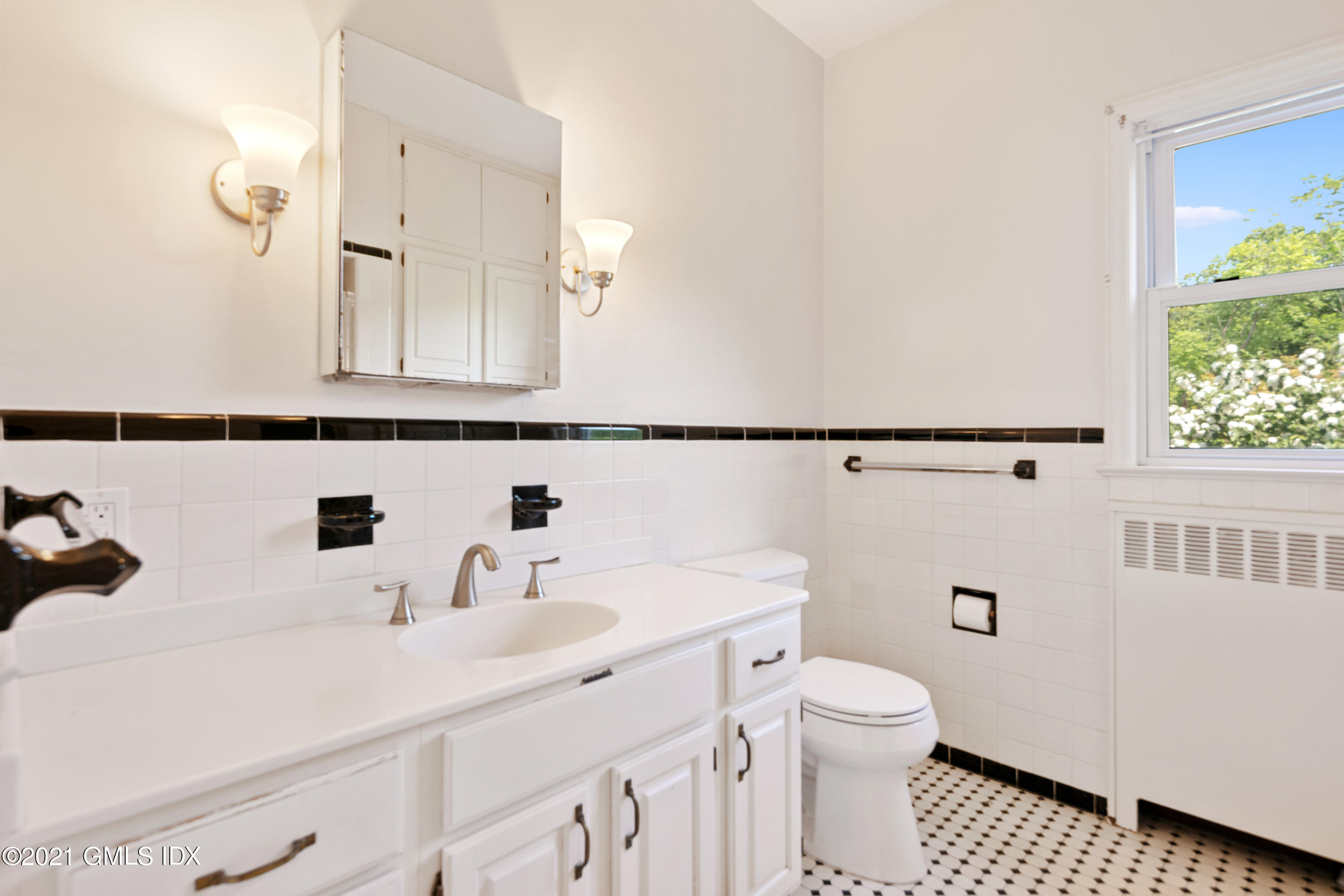 14 Byram Shore Road, Unit 1 Greenwich, CT 06830 - Photo 17 of 30 a bathroom with a sink toilet and mirror