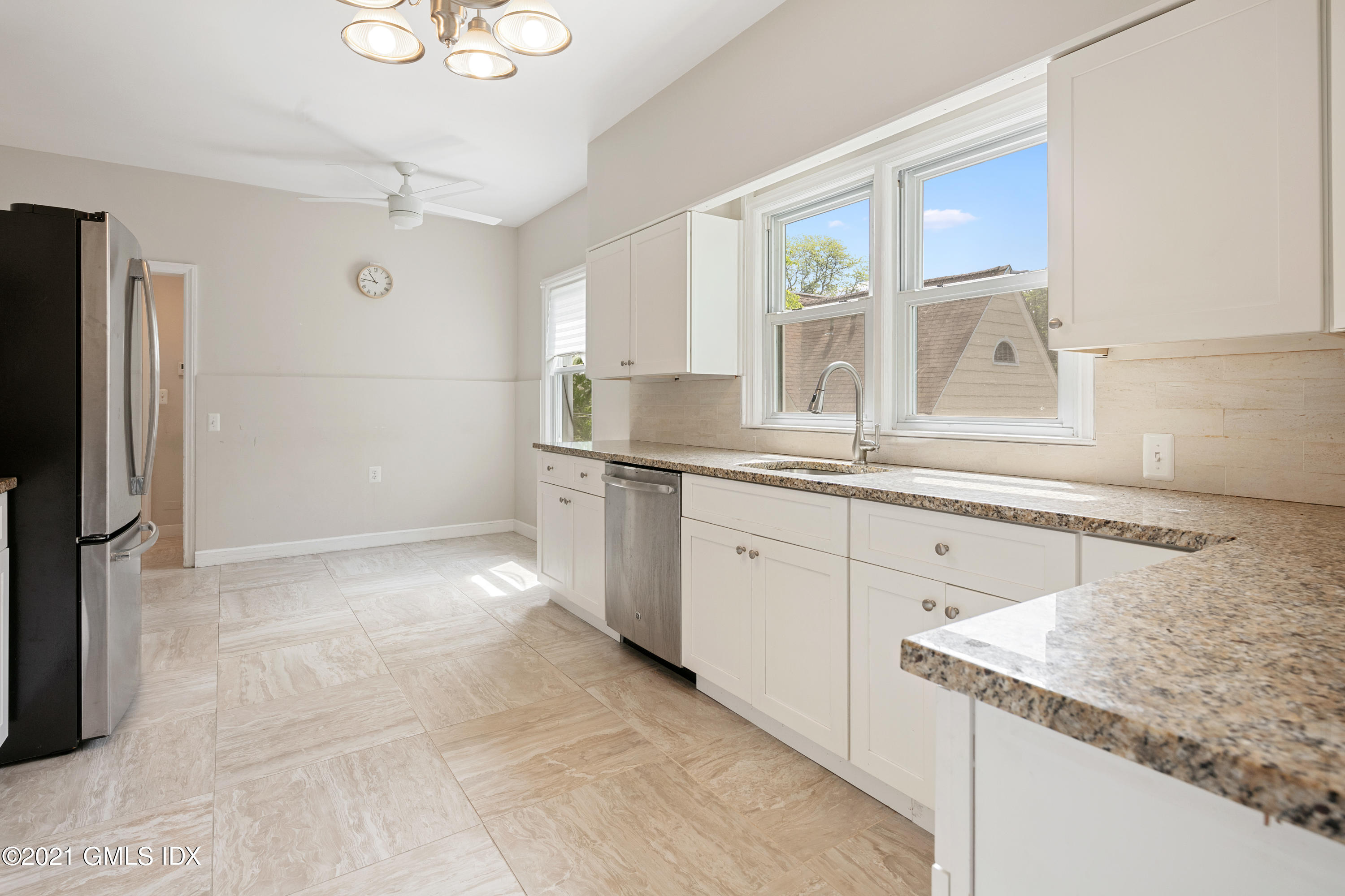 14 Byram Shore Road, Unit 1 Greenwich, CT 06830 - Photo 21 of 30 a kitchen with granite countertop a sink stainless steel appliances and cabinets
