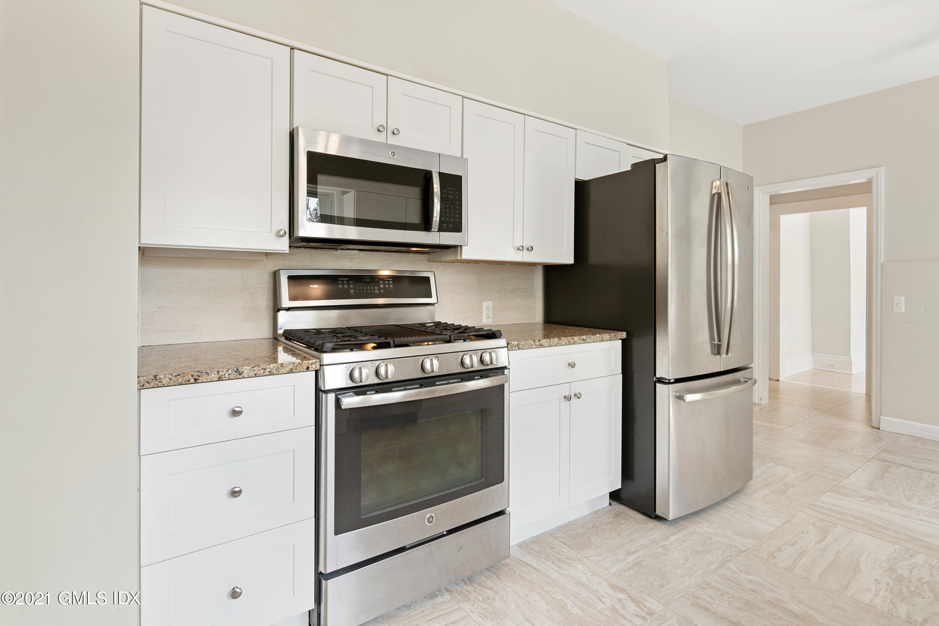 14 Byram Shore Road, Unit 1 Greenwich, CT 06830 - Photo 22 of 30 a kitchen with a stove microwave and refrigerator