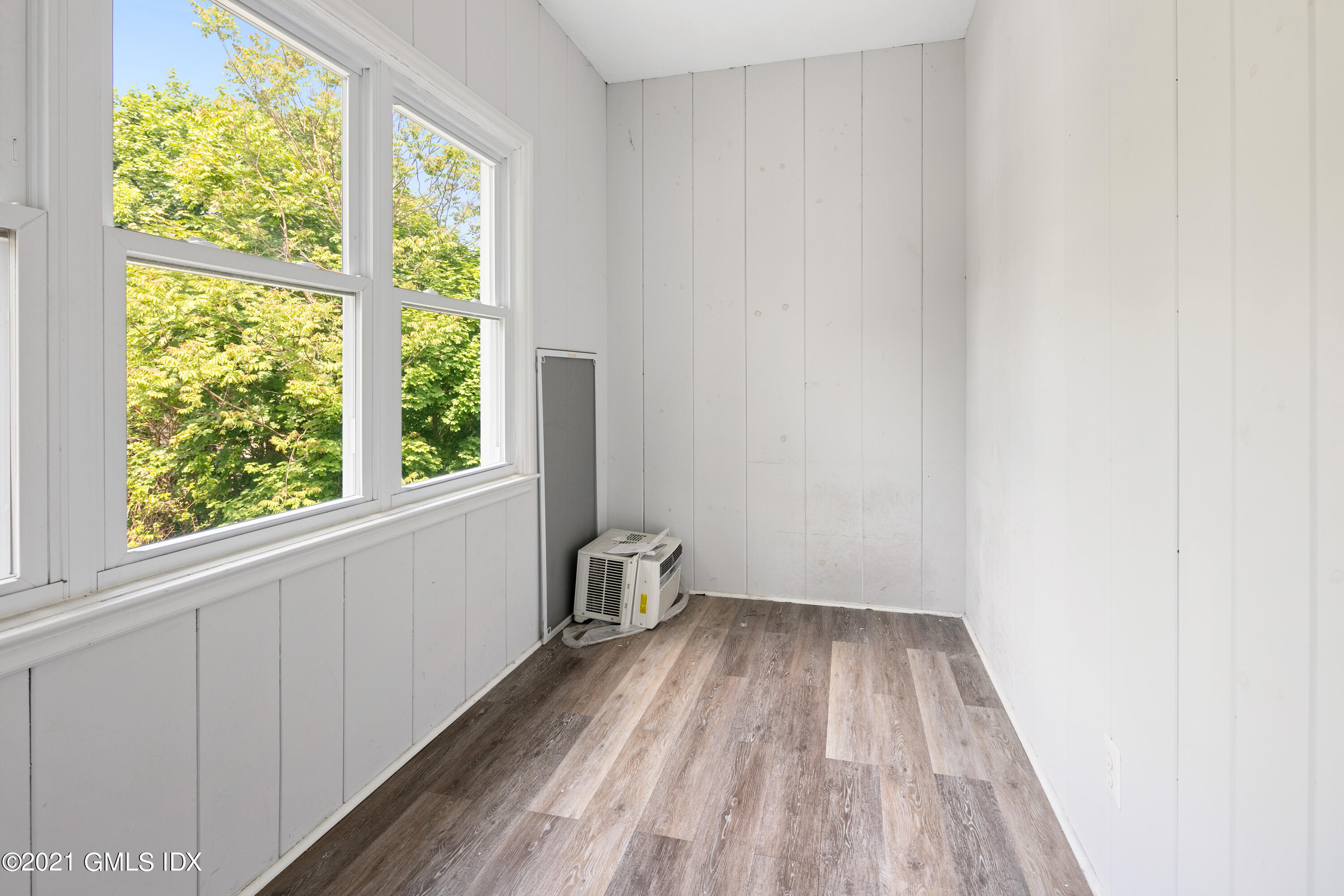 14 Byram Shore Road, Unit 1 Greenwich, CT 06830 - Photo 24 of 30 a view of a room with wooden floor and fence