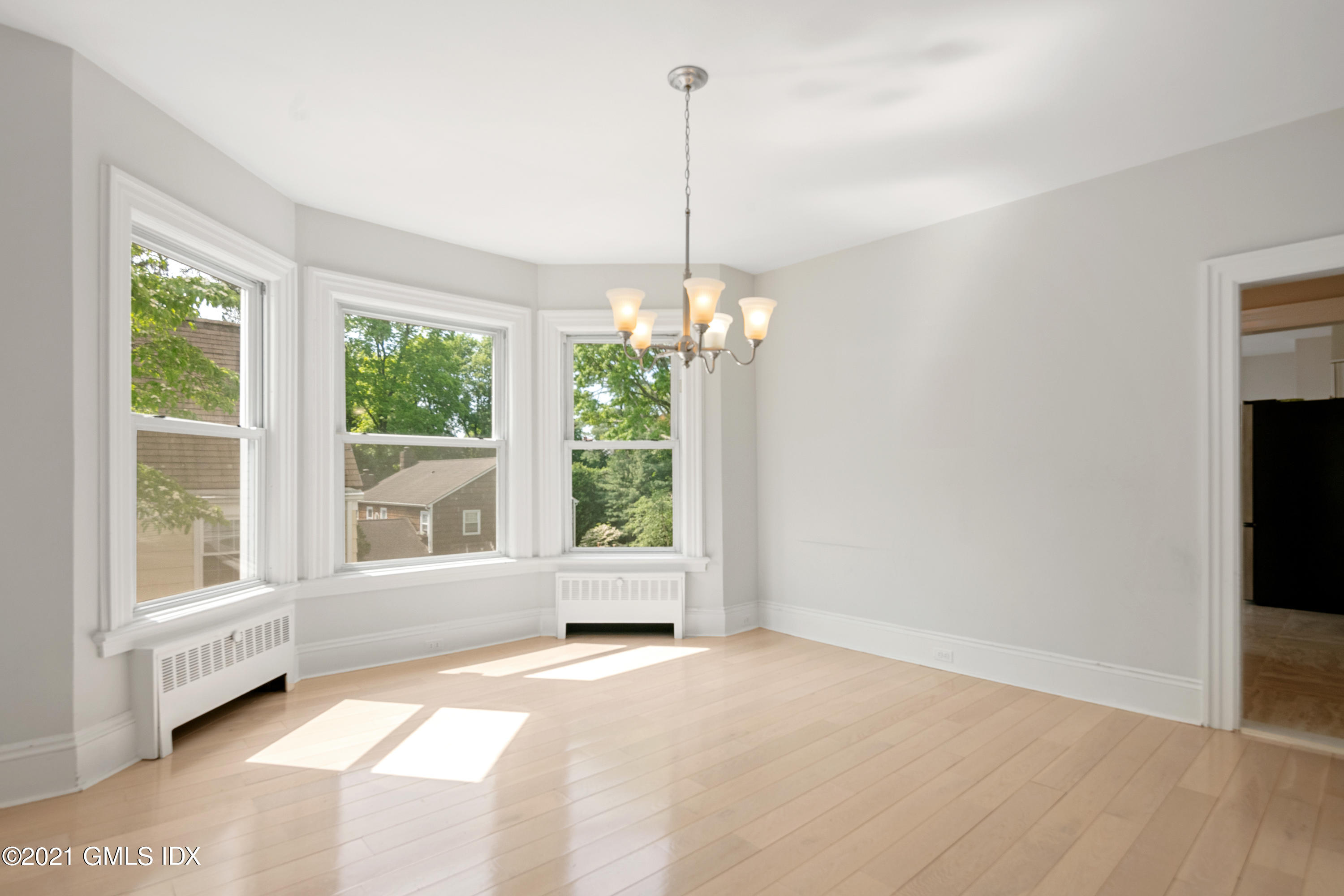14 Byram Shore Road, Unit 1 Greenwich, CT 06830 - Photo 6 of 30 a view of an empty room with a window and chandelier