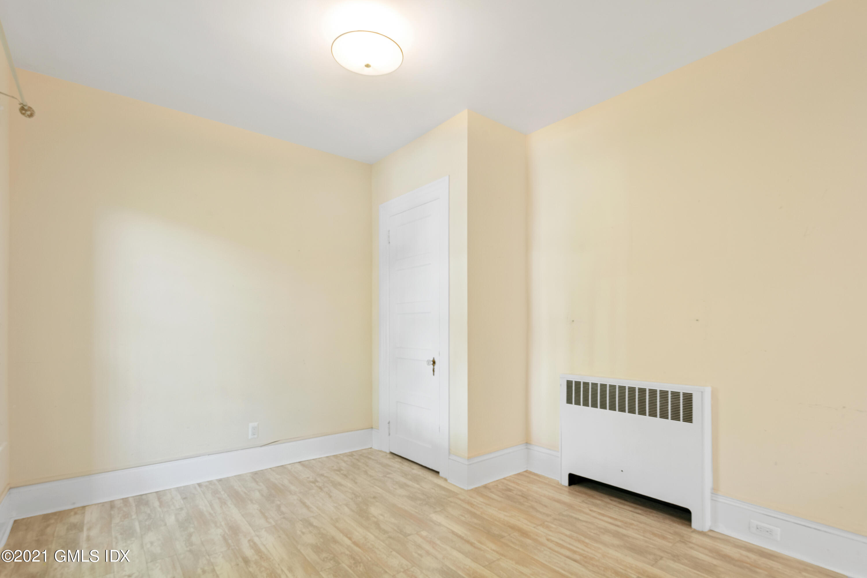 14 Byram Shore Road, Unit 1 Greenwich, CT 06830 - Photo 10 of 30 a view of a room with wooden floor and fence