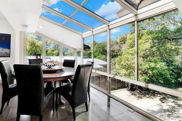 a view of a dining room with furniture and a window