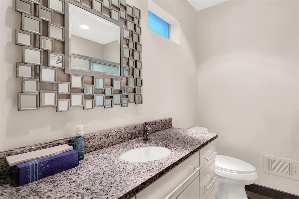 13311 Purple Sage Road Dallas, TX 75240 - Photo 16 of 31 a bathroom with a granite countertop sink and a mirror
