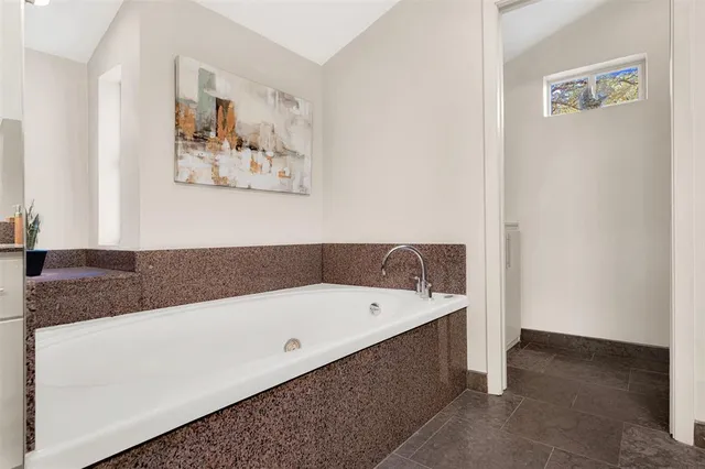 a bathroom with a tub a sink and a shower