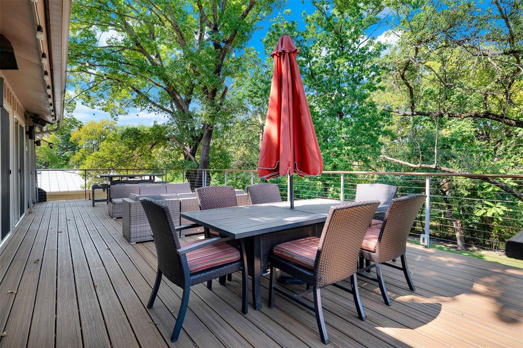 13311 Purple Sage Road Dallas, TX 75240 - Photo 21 of 26 a view of a roof deck with table and chairs a barbeque with wooden floor and fence