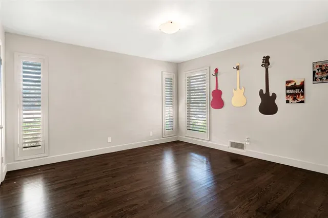 a view of a room with wooden floor and white cabinet