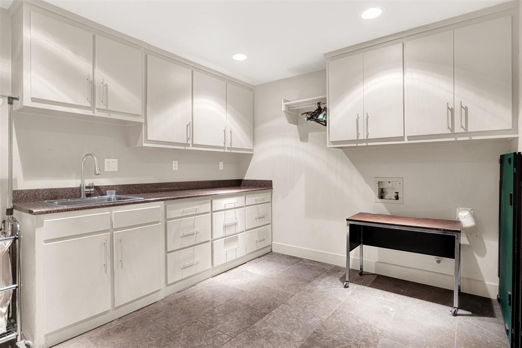 13311 Purple Sage Road Dallas, TX 75240 - Photo 27 of 31 a kitchen with granite countertop a sink and cabinets