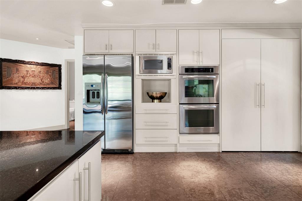 13311 Purple Sage Road Dallas, TX 75240 - Photo 8 of 26 a kitchen with granite countertop white cabinets and stainless steel appliances
