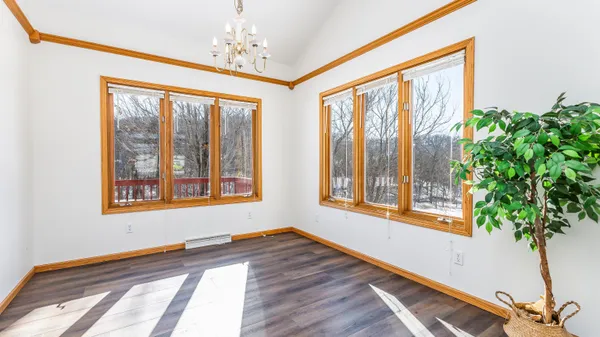 a living room with stainless steel appliances granite countertop furniture and a window