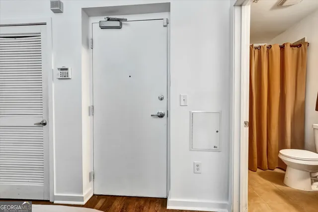 a living room with furniture and kitchen view