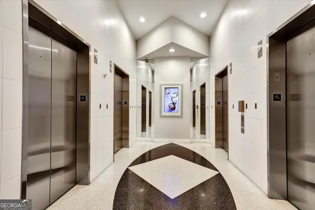 a living room with furniture kitchen view and a large window