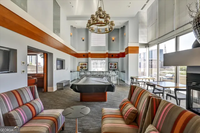 a living room with furniture a large window