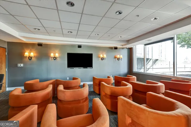 a dining hall with stainless steel appliances granite countertop a stove a sink and a microwave