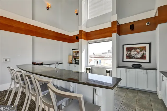 a living room with fireplace furniture and a large window