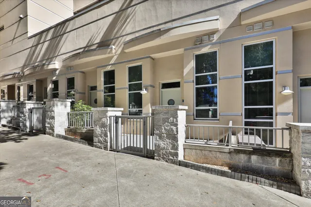 a view of a house with a wooden fence