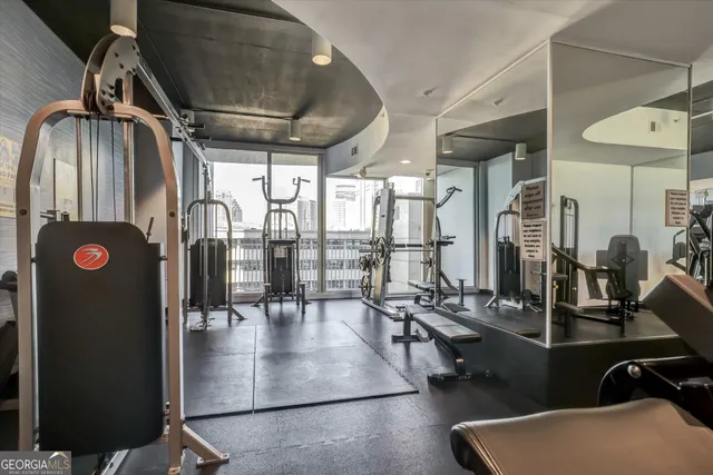 a room with gym equipment and a large window