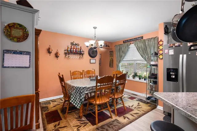a dining room with furniture entryway and wooden floor