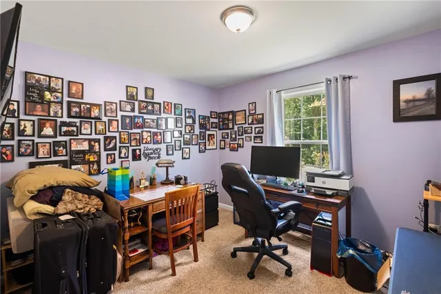 a view of a workspace with furniture and a bookshelf