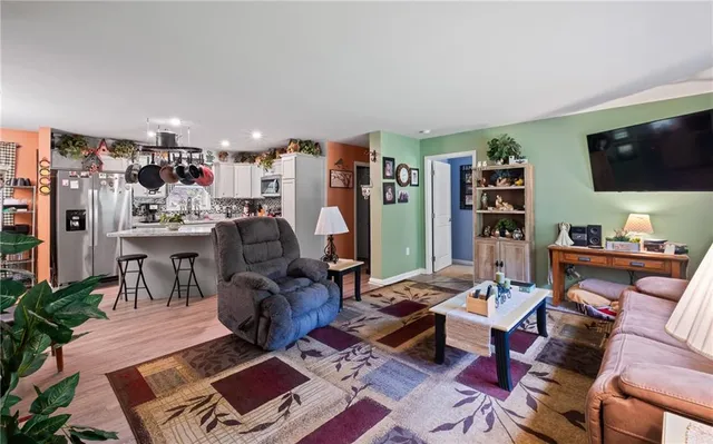 a living room with lots of furniture and a flat screen tv