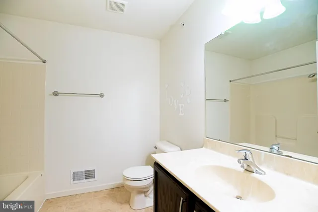 a bathroom with a sink toilet and vanity