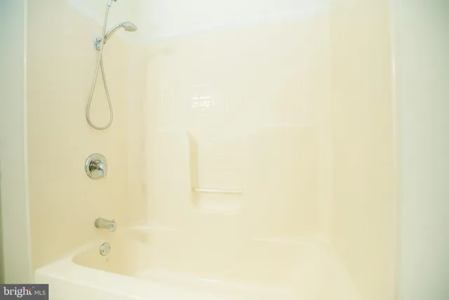 a bathroom with a bath tub and shower