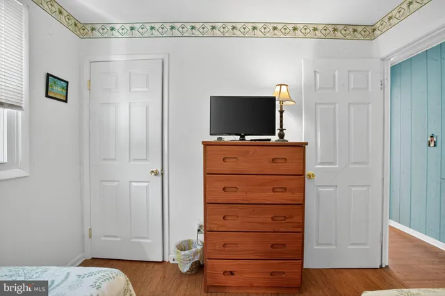a room with a television and a dresser