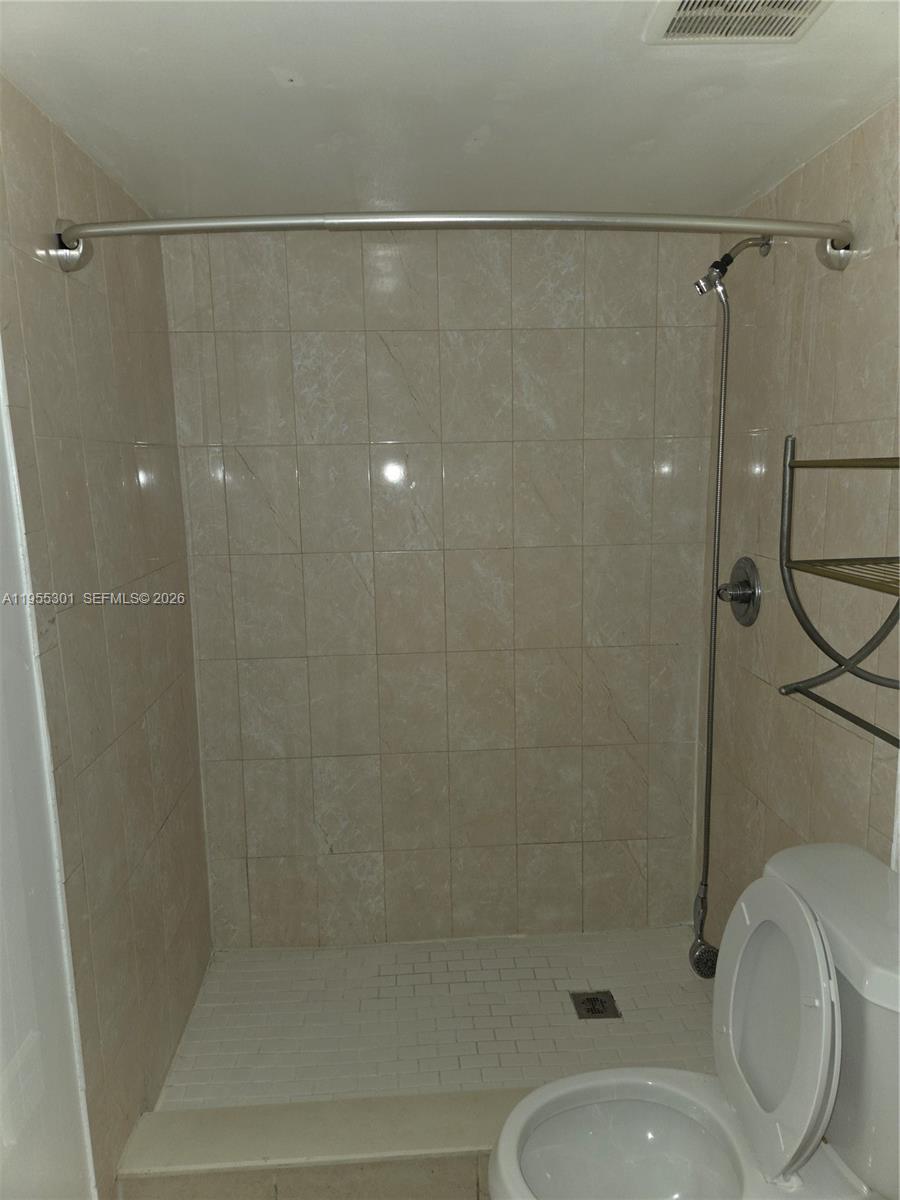 17901 Northwest 68th Avenue, Unit T106 Hialeah, FL 33015 - Photo 16 of 31 a bathroom with a shower and a toilet