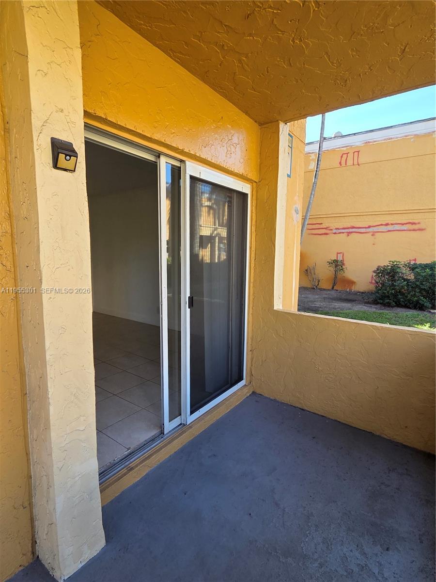 17901 Northwest 68th Avenue, Unit T106 Hialeah, FL 33015 - Photo 21 of 31 a view of an empty room with a window
