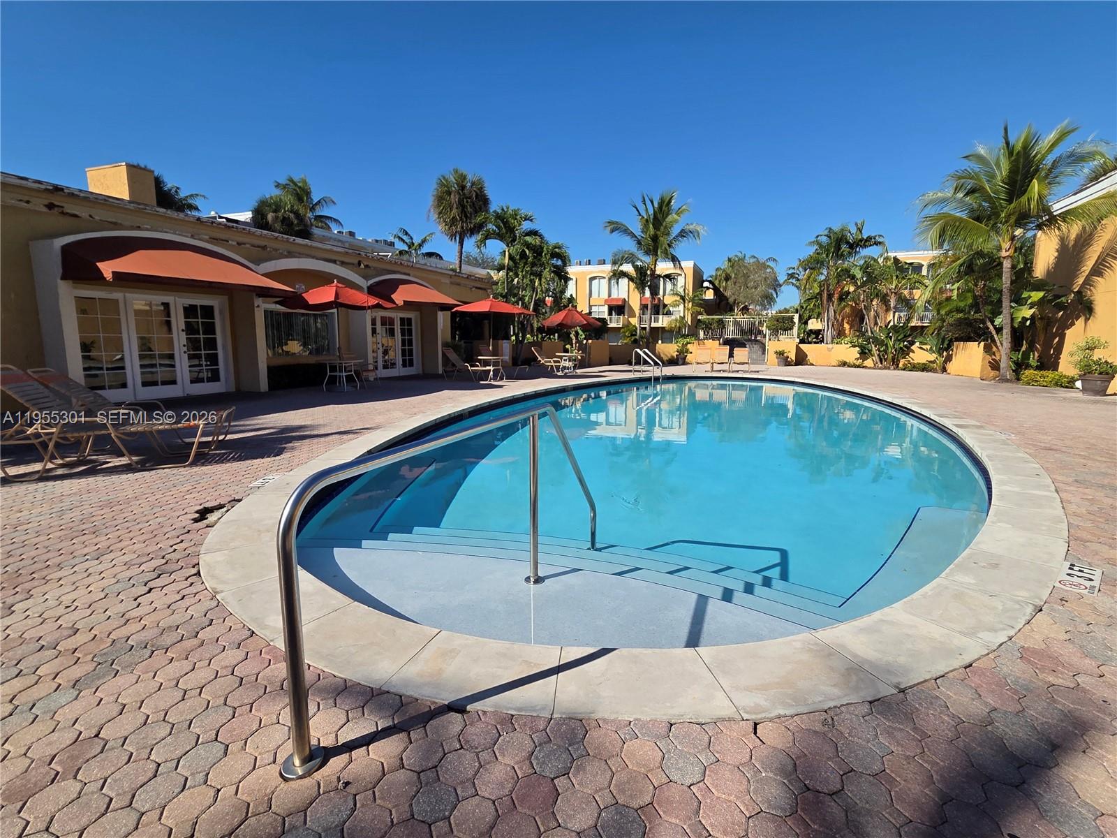 17901 Northwest 68th Avenue, Unit T106 Hialeah, FL 33015 - Photo 25 of 31 a view of a swimming pool with a patio