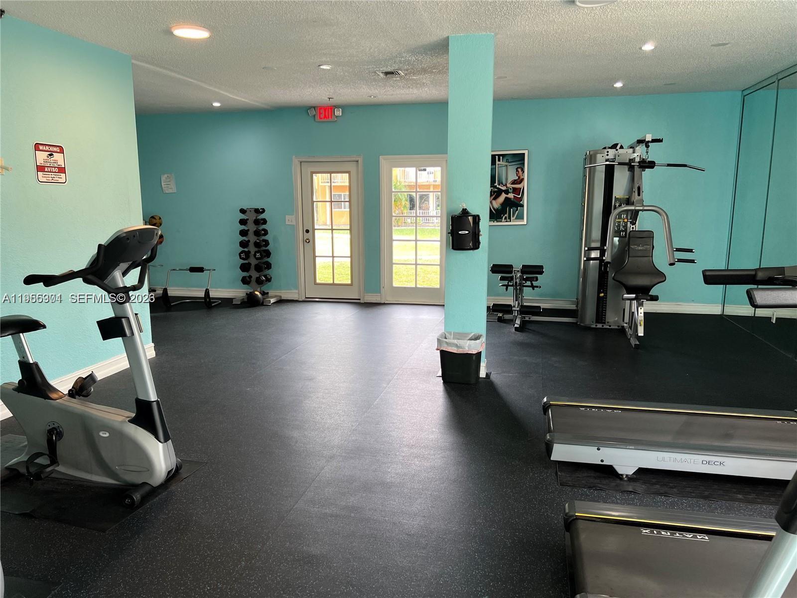 17901 Northwest 68th Avenue, Unit T106 Hialeah, FL 33015 - Photo 29 of 31 a view of a room with gym equipment