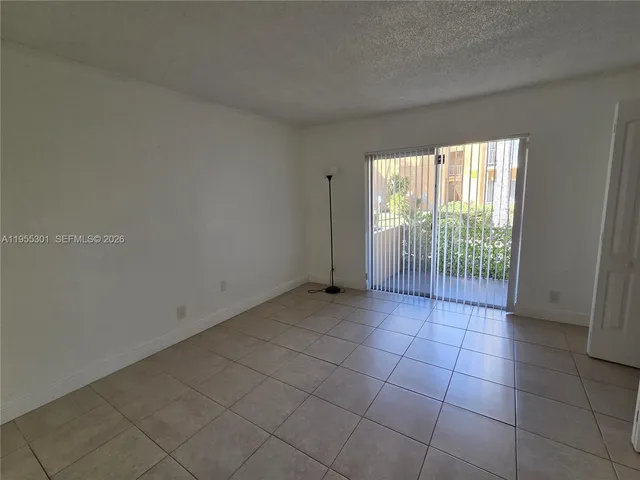 a view of a livingroom with an empty space and a window