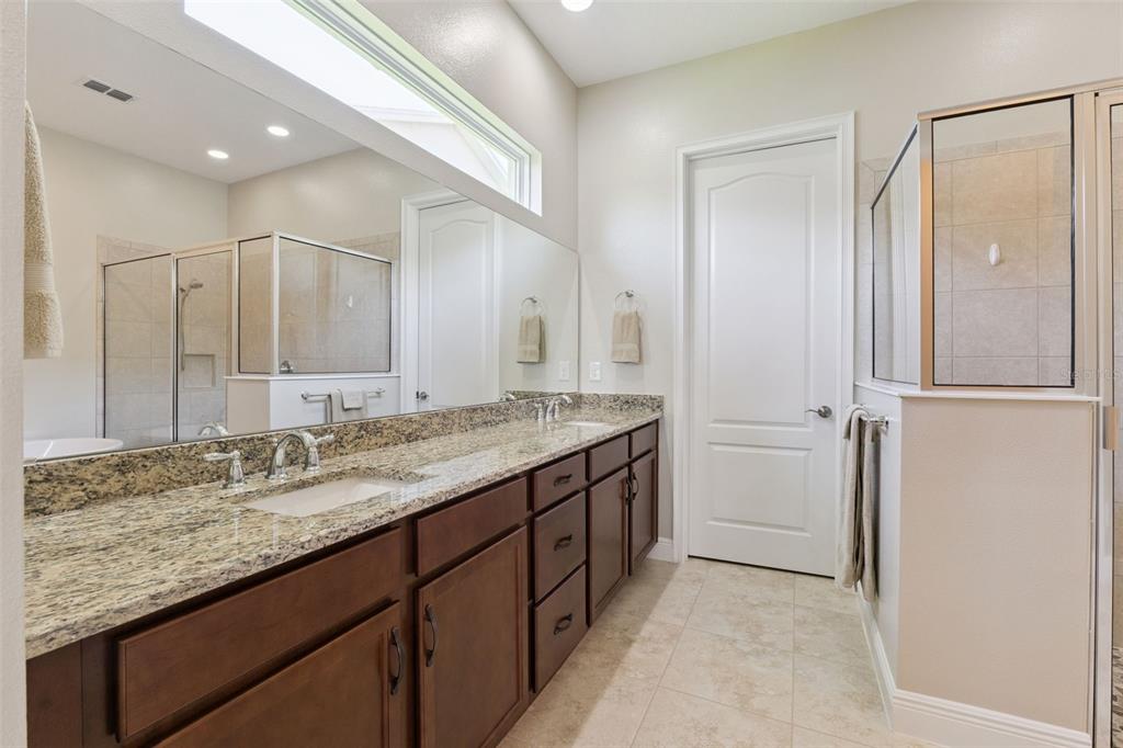 2665 Meadowedge Loop St. Cloud, FL 34772 - Photo 29 of 53 a bathroom with a granite countertop sink and a mirror