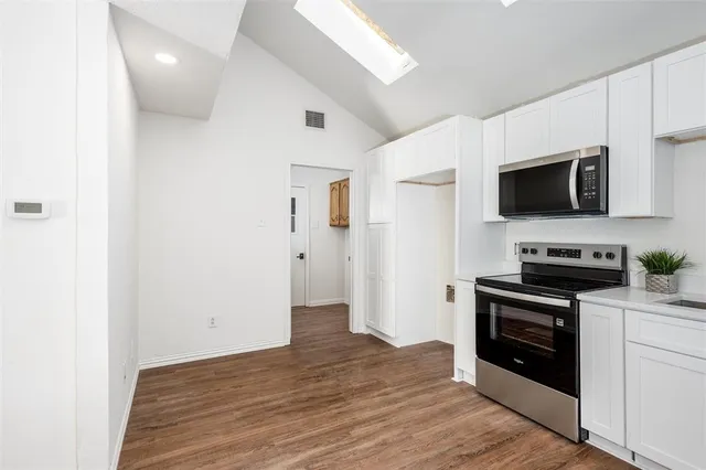 a kitchen with a stove and a microwave
